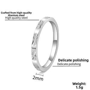 Detail showing 2mm width and 1.5g weight of silver titanium steel ring with star engraving