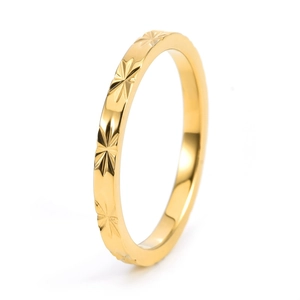 Polished 18K gold-plated titanium steel ring with starburst pattern on white background