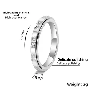 Macro view of 3mm wide silver stainless steel spinner ring with star engravings