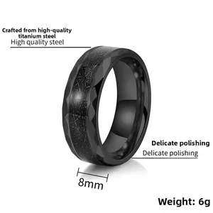 Macro view of 8mm black titanium steel ring with brushed texture and faceted edges