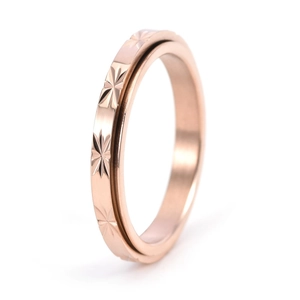 Detailed close-up of 3mm rotating stainless steel ring with 18K gold star pattern