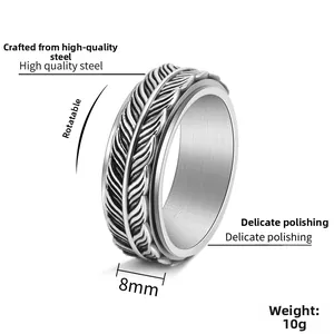 Macro view of 8mm rotating steel ring with intricate feather patterns and relief texture