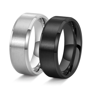 Detail of couple rings showing silver and black brushed metal with polished edges