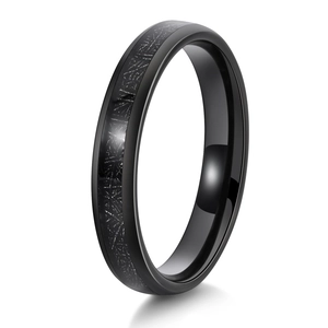 Detail of minimalist black tungsten ring featuring silver meteorite textured inlay