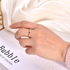 Detail of 18K gold-plated titanium ring with faceted star pattern on a hand