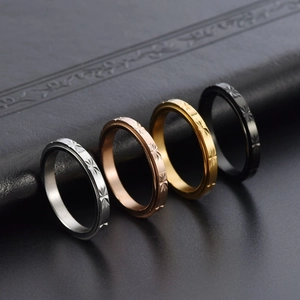 Set of four stainless steel rotating rings with star engraving in multiple finishes