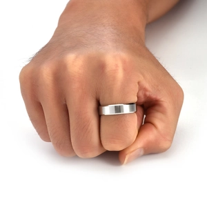 Silver brushed titanium steel men's ring with polished beveled edges shown on a hand