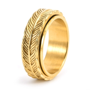 Detailed close-up of golden vintage spinner ring with engraved feather texture details