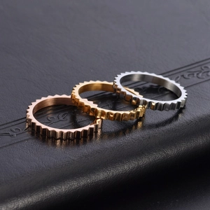 Irregular gear-shaped stainless steel rings in gold, silver, and rose gold finishes