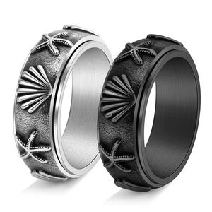 Rotating stainless steel ocean ring set featuring vintage starfish and shell relief patterns
