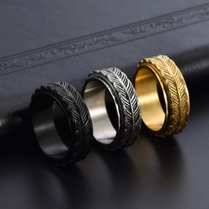 Men's spinning stainless steel rings with feather textures in black, silver, and gold