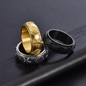 Rotating ocean theme spinner rings with starfish and shell relief in gold, silver and black