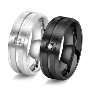 Detailed macro view of brushed titanium steel rings with single square set zircon