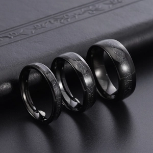Polished black tungsten steel ring set featuring laser-etched geometric meteorite texture