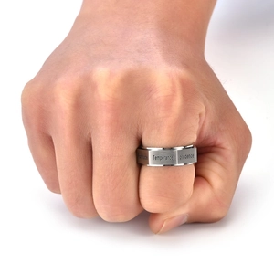 Macro shot of silver rotating virtues ring for men with Fortitude and Prudence engraving