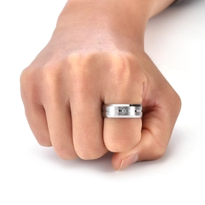 Macro detail of men's brushed titanium ring with a square-cut sparkling gemstone inlay