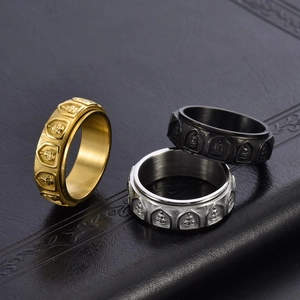 Rotating stainless steel Buddhist rings set in gold, silver, and black finishes