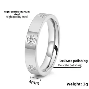 Detail of 4mm titanium steel ring with cross pattern and embedded zircon crystals