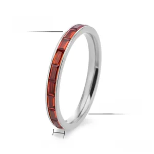 Macro detail of 2.5mm titanium steel ring with inlaid rectangular red zircons