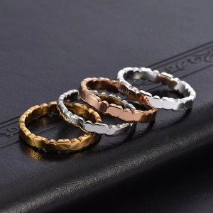 Set of four stacked heart-shaped rings in gold, rose gold and silver stainless steel