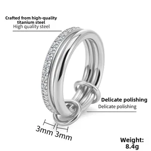 Close-up of a 3-layer stacked titanium steel ring with micro-pave cubic zirconia accents