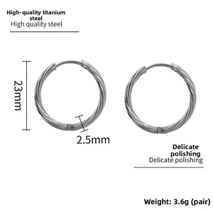 Detail view of twisted silver titanium steel hoop earrings with 23mm diameter measurement