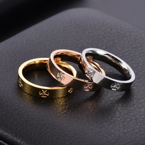 Three minimalist 18K gold and silver titanium steel rings with cross pattern and crystals