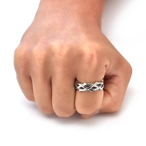 Detailed macro view of silver thorn vine stainless steel ring worn on finger