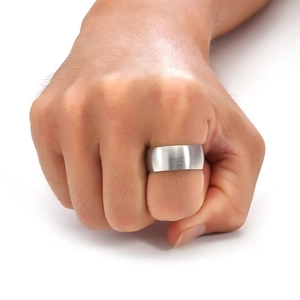 Close-up of a silver brushed titanium steel ring showcasing the metallic matte texture