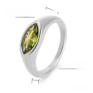 Macro detail of a 2mm steel ring featuring a 7mm marquise-cut yellow-green gemstone