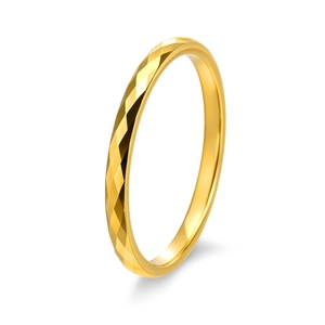 Macro detail of gold tungsten ring featuring geometric faceted cut texture and mirror finish