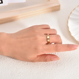 Close-up of 18K gold plated titanium steel ring with hollow cross star and crystal on finger