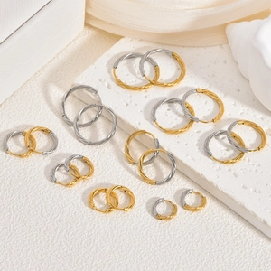 Detailed view of twisted rope textured hoop earrings in gold and silver finishes