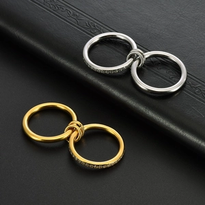 Detailed macro view of interlocking gold and silver rings with sparkling crystal settings
