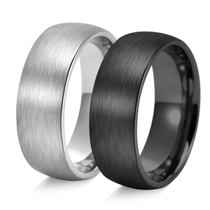 Detail view of brushed silver and black titanium steel rings with polished interiors