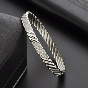 Unisex titanium steel silver twisted cable bracelet with textured pattern on black gift box