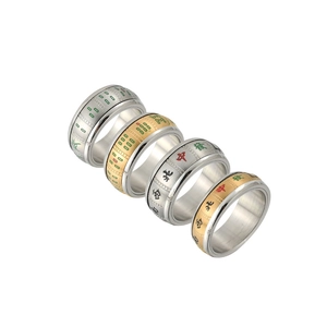 Detail view of four rotating mahjong rings in gold and silver stainless steel finish