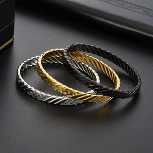 Three-piece set of twisted rope steel bracelets in gold, silver, and black finishes