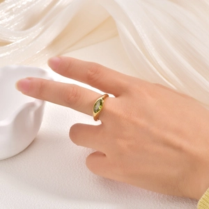 Detailed view of an 18K gold stainless steel ring with a marquise-cut green zircon