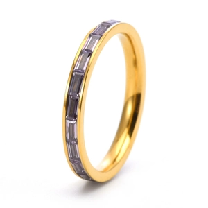 Detailed macro view of 18K gold eternity ring with baguette-cut purple gemstones