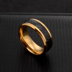 8mm gold stainless steel ring with black carbon fiber inlay at a 45-degree angle