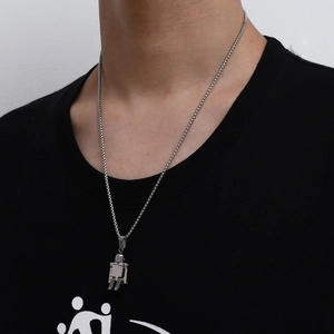 Detail view of movable robot pendant on silver box chain for men's fashion jewelry