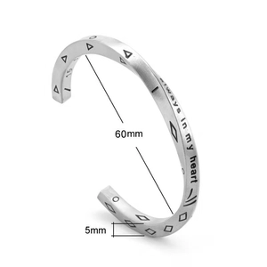 Detail view of titanium steel cuff bracelet showing engraved letters and 5mm width scale