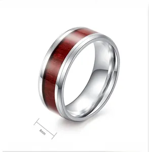 Macro detail of 8mm titanium steel ring with inlaid reddish-brown wood texture