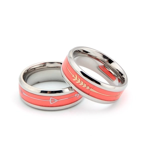 Détail de bagues en acier inoxydable avec insert rouge corail et motif flèche argent