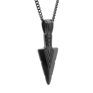 Close-up of black titanium steel arrowhead pendant with geometric engraved lines