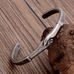 Retro titanium steel C-shaped open bracelet featuring a handshake design on rustic wood