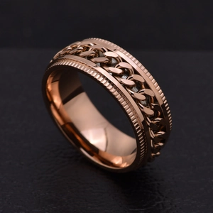 Macro view of rose gold rotatable chain ring with gear textured edges for men
