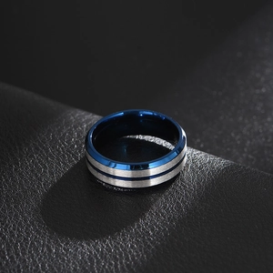 Macro view of brushed silver titanium ring with bright blue plated inner groove