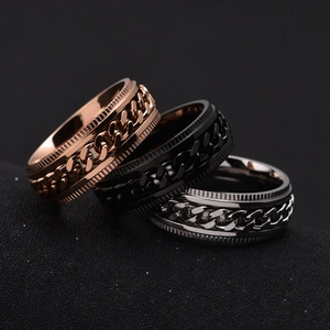 Detail of spinning gear chain rings in rose gold, black, and silver stainless steel finishes